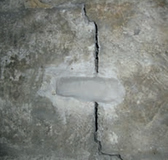 Mortar dab across a crack-movement in historic buildings 