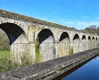 Assessment of Load Carrying Capacity in Heritage Masonry Arches
